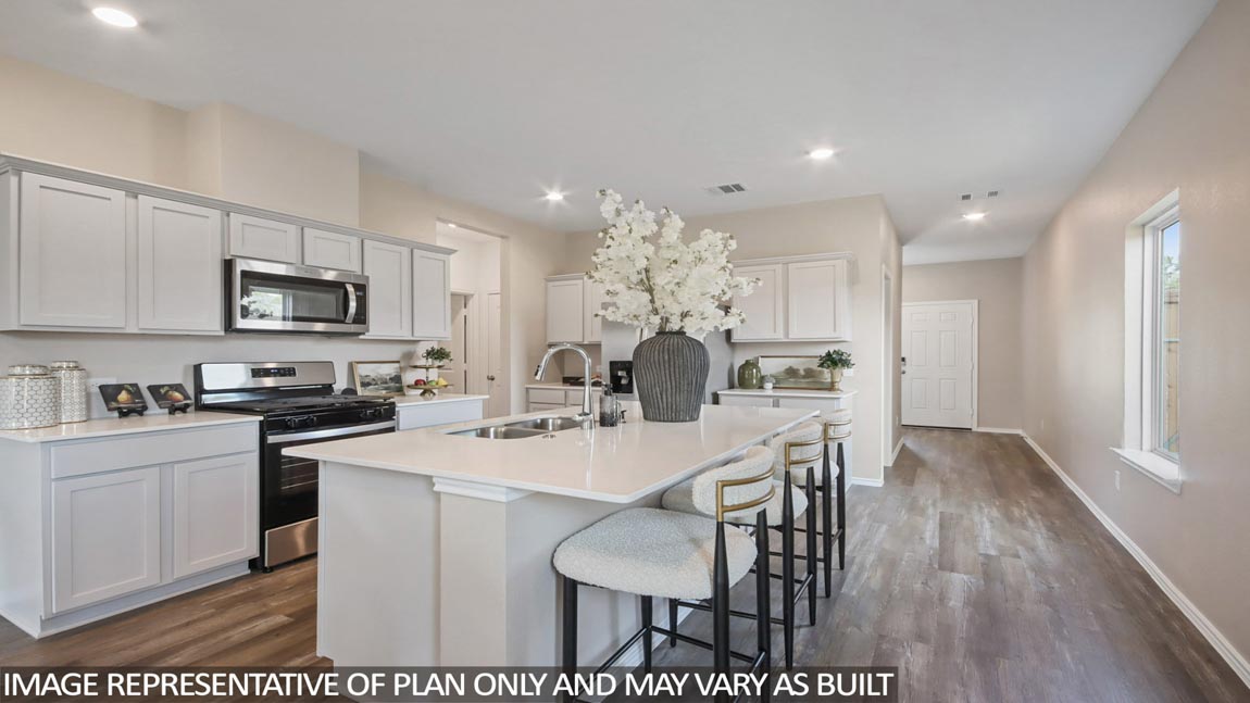 Staged kitchen with stainless-steel appliances and an island.
