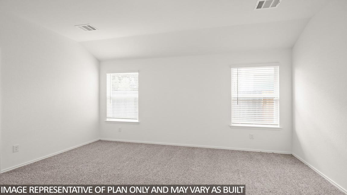 Primary bedroom with bright windows