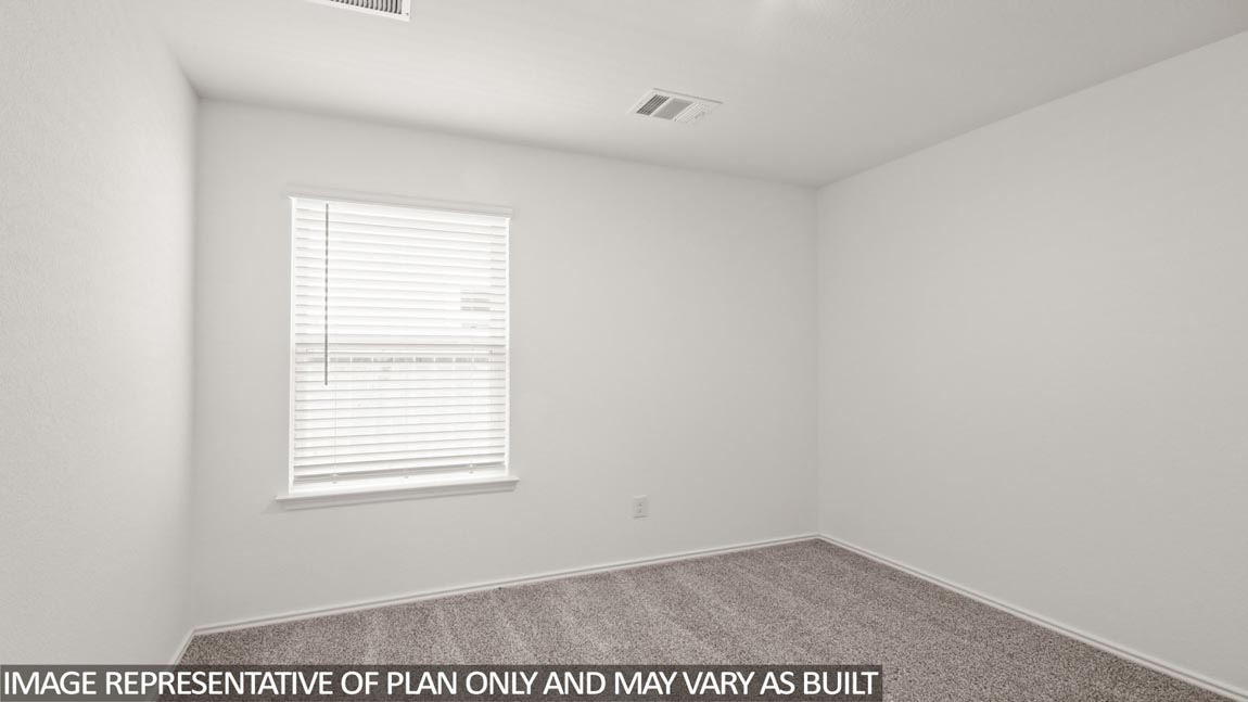 Secondary bedroom with carpet flooring