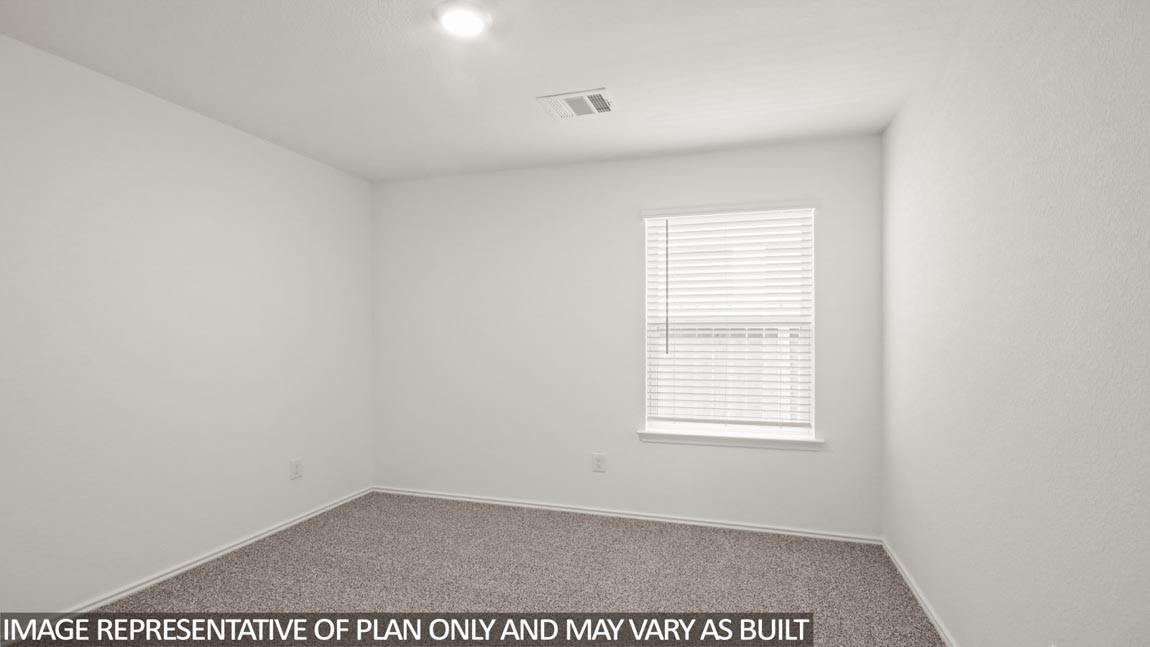 Secondary bedroom with carpet flooring