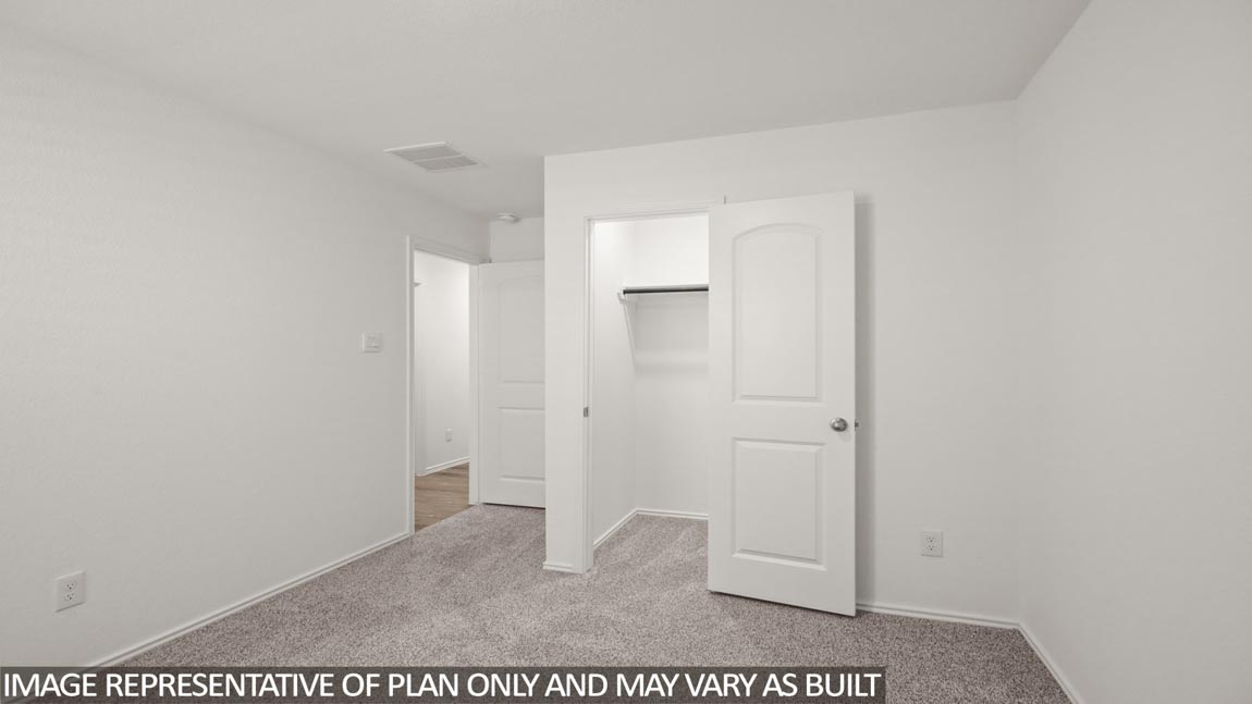 Secondary bedroom with carpet flooring