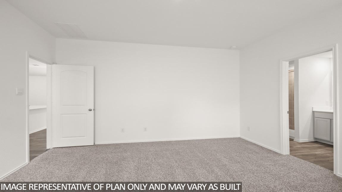Primary bedroom with carpet flooring