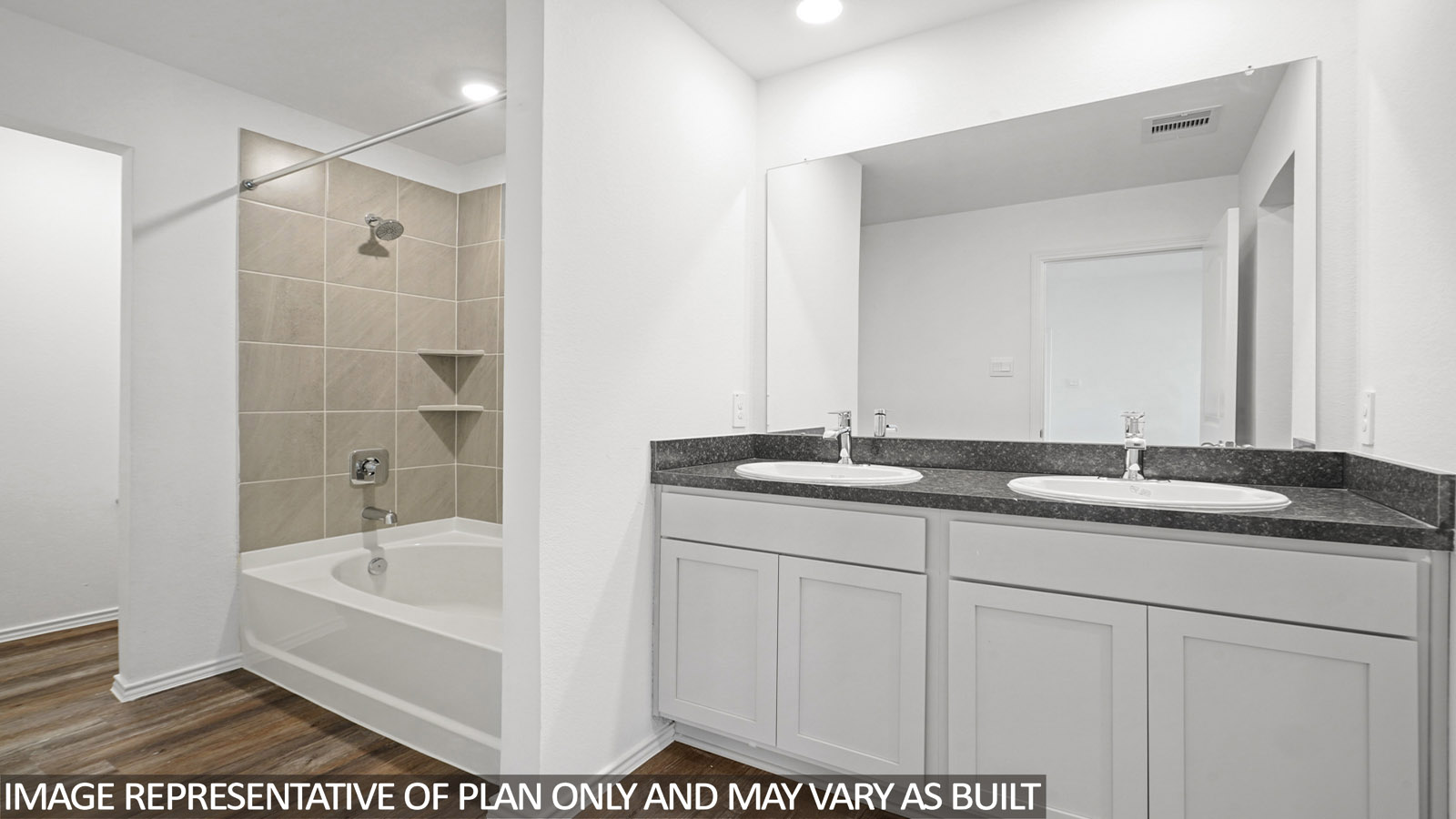 primary bathroom with dual sink and a tub/shower combo