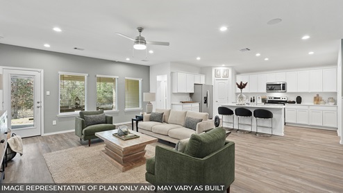 Spacious living area with vinyl flooring