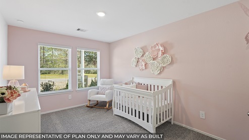 Secondary bedroom with carpet flooring