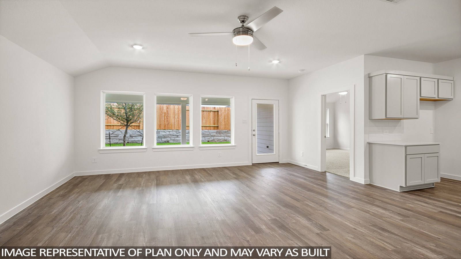 Spacious living area with vinyl flooring