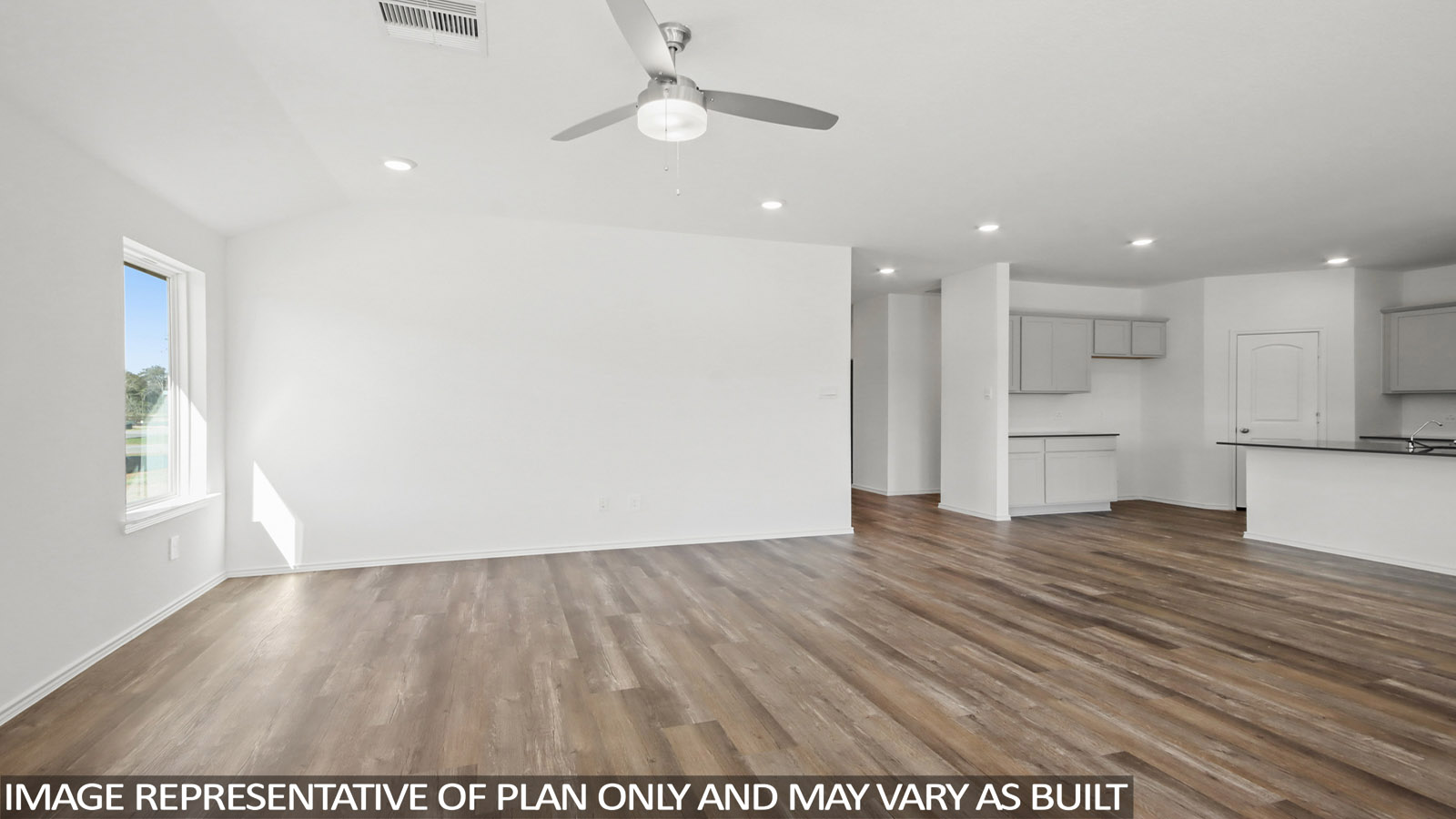 Spacious living area with vinyl flooring
