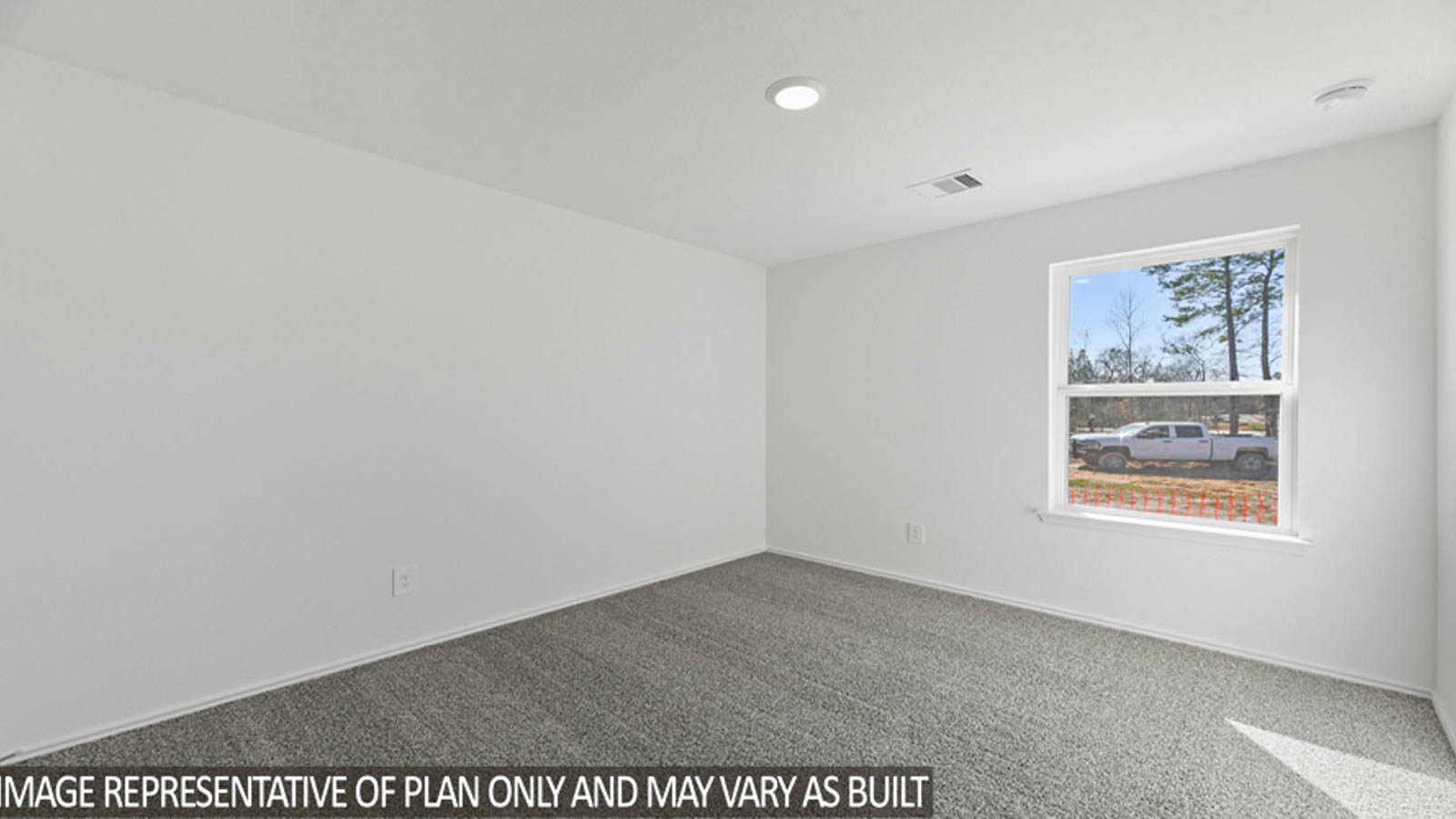 Secondary bedroom with carpet flooring