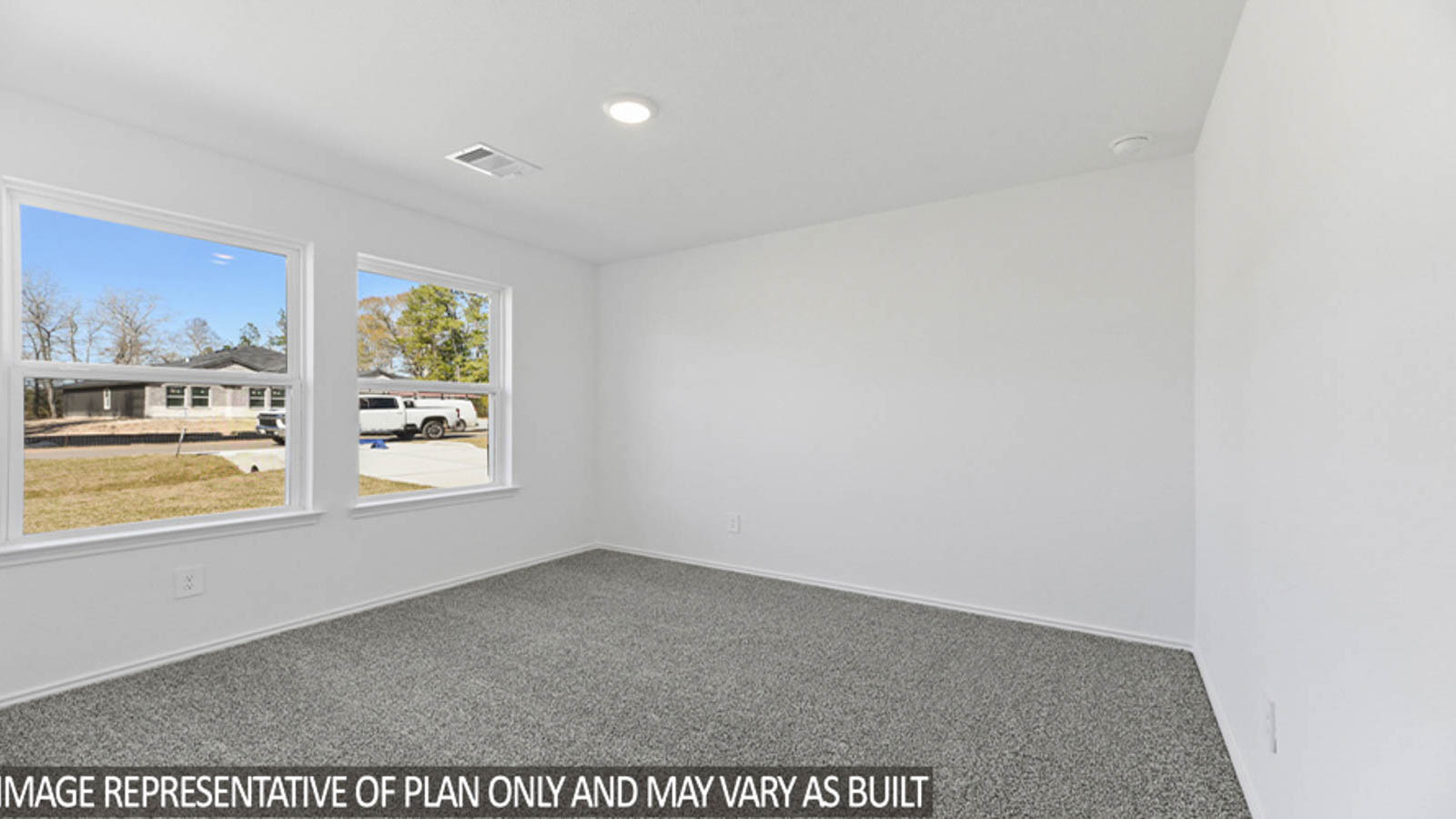 Secondary bedroom with carpet flooring