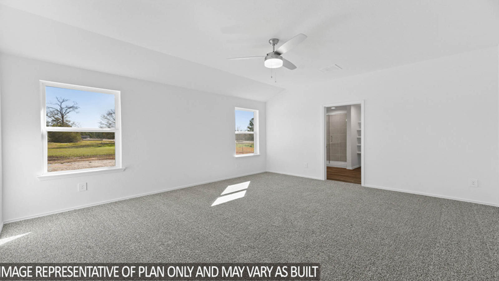 Primary bedroom with carpet flooring