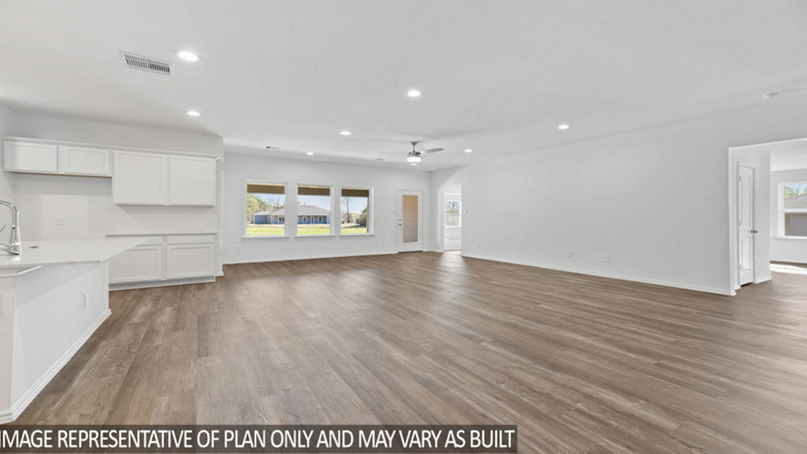 Spacious living area with vinyl flooring