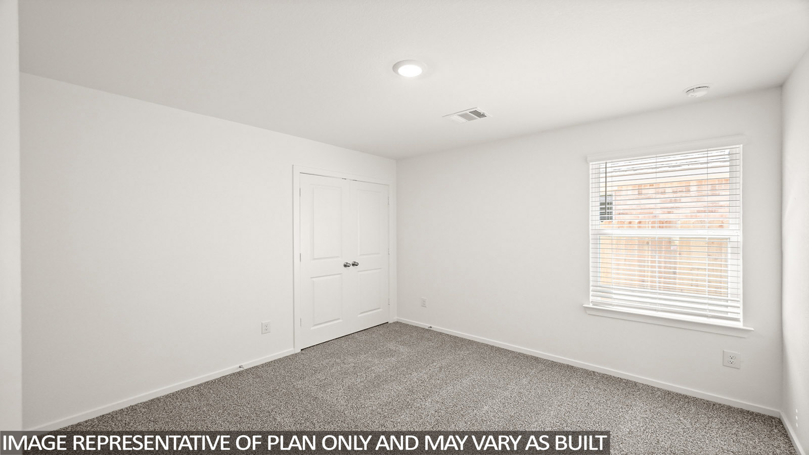 Secondary bedroom with carpet flooring