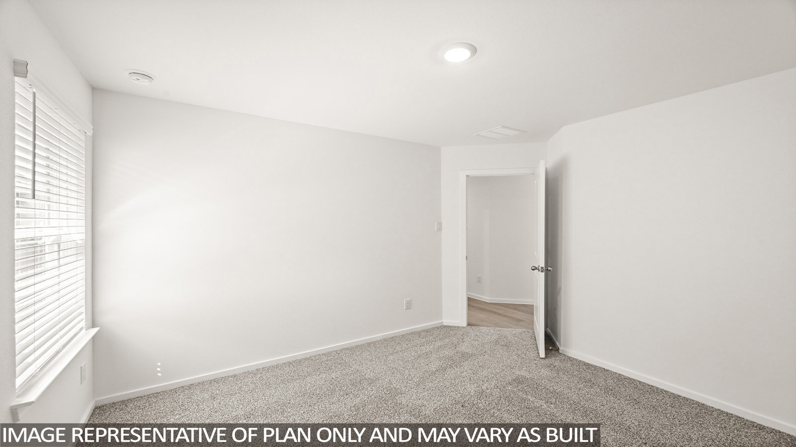 Secondary bedroom with carpet flooring