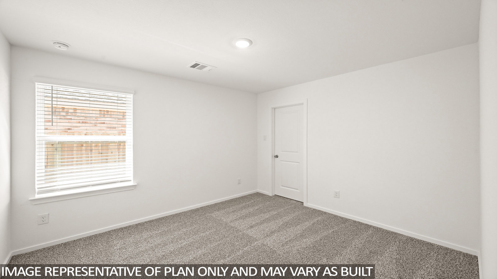 Secondary bedroom with carpet flooring