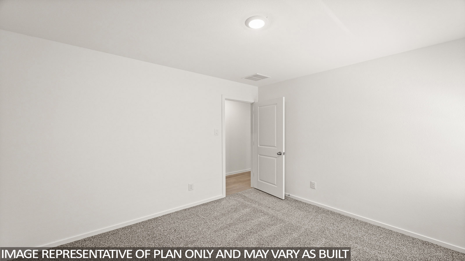 Secondary bedroom with carpet flooring