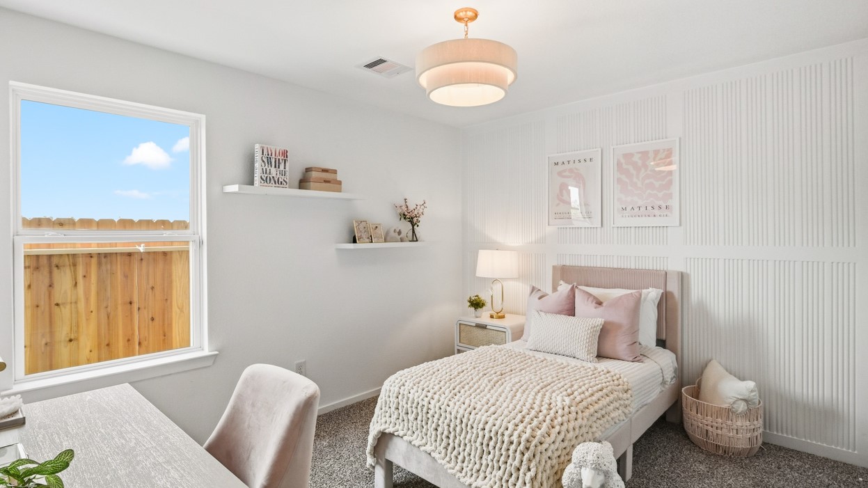 Secondary bedroom with carpet flooring