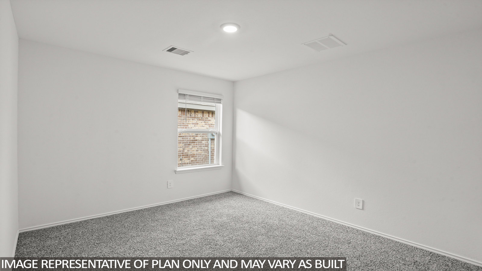 Secondary bedroom with carpet flooring
