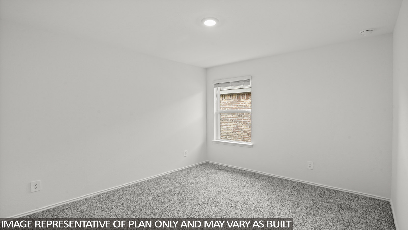 Secondary bedroom with carpet flooring