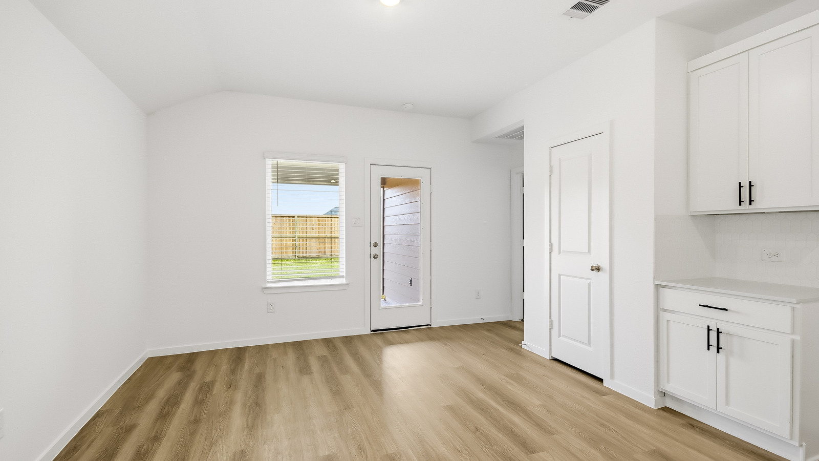 Spacious living area with vinyl flooring