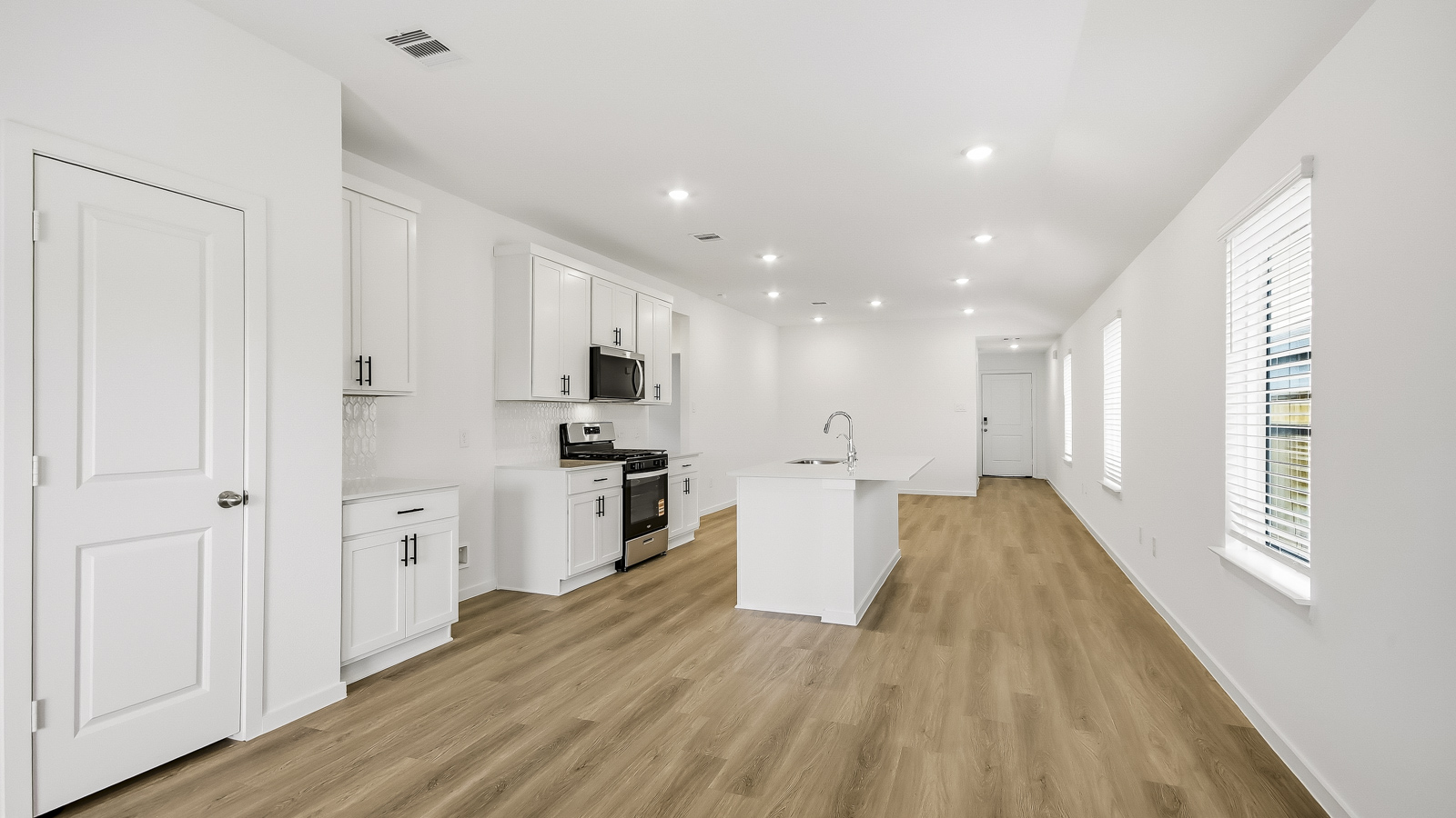 Spacious living area with vinyl flooring