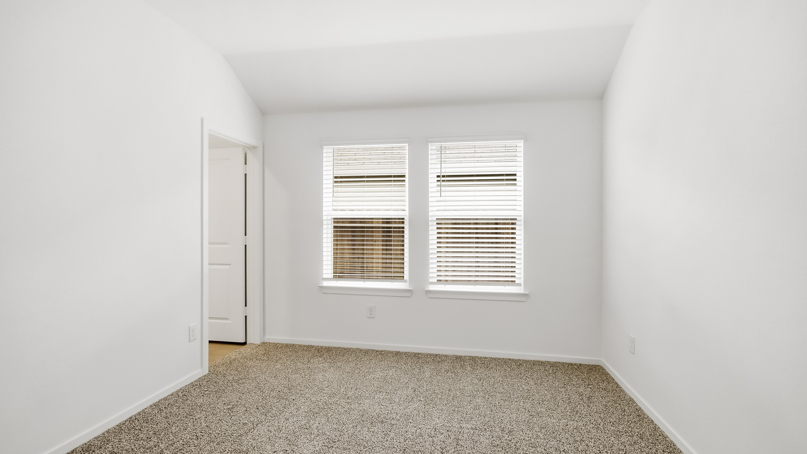 Primary bedroom with carpet flooring