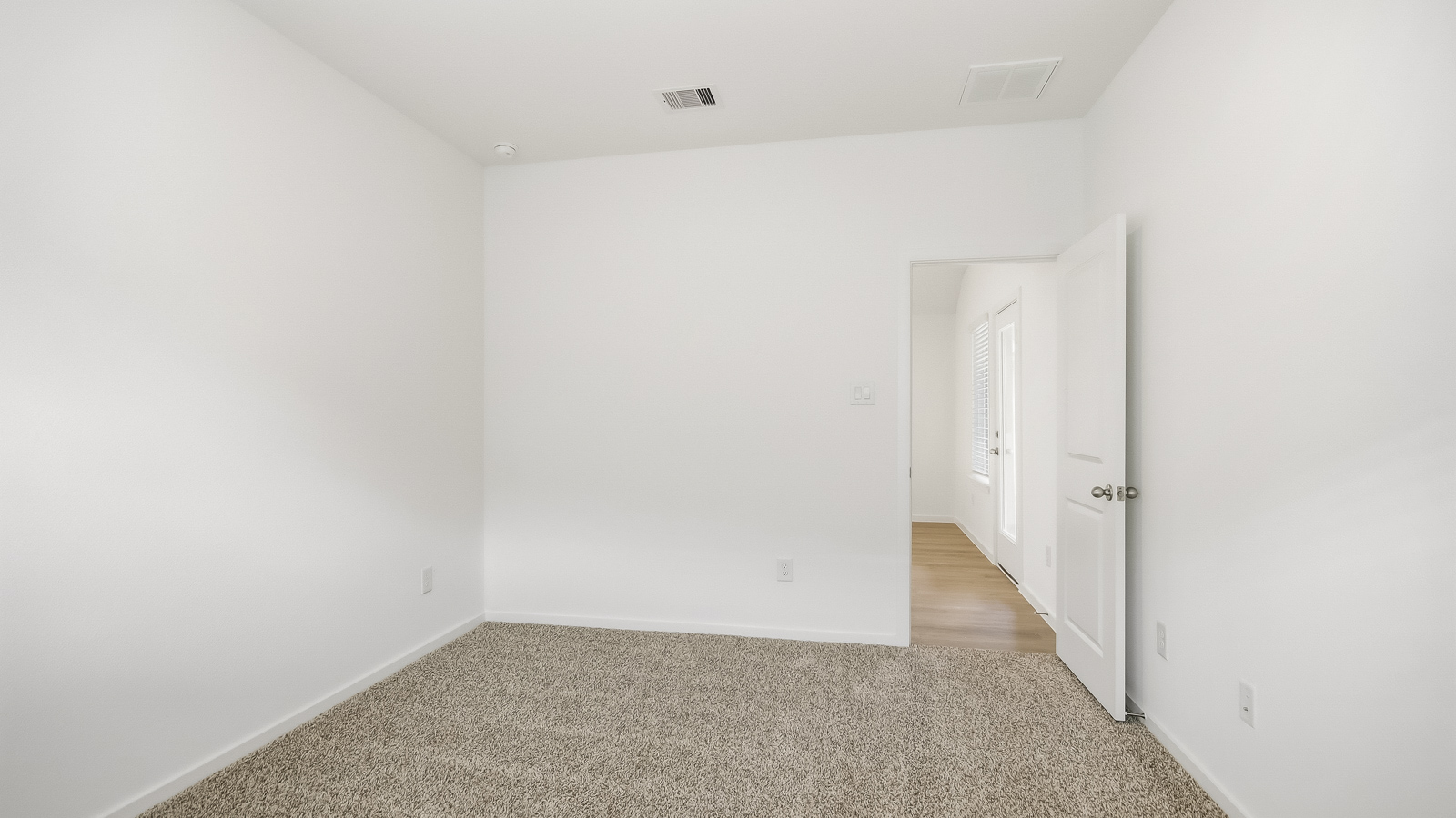 Primary bedroom with bright windows
