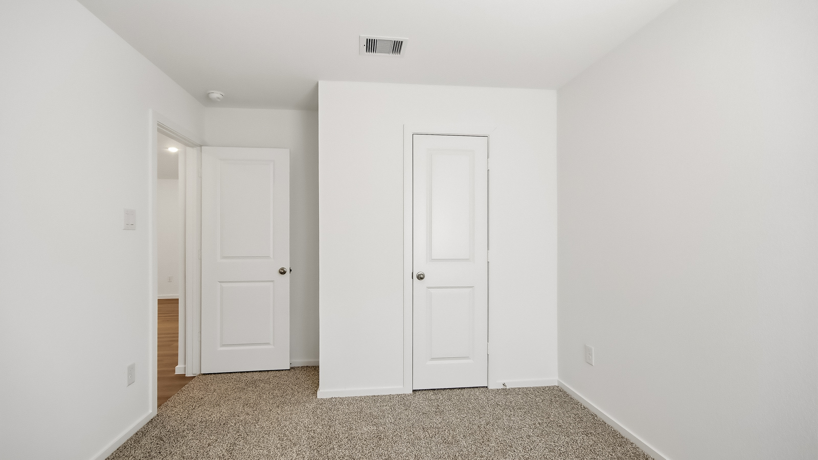 Secondary bedroom with carpet flooring