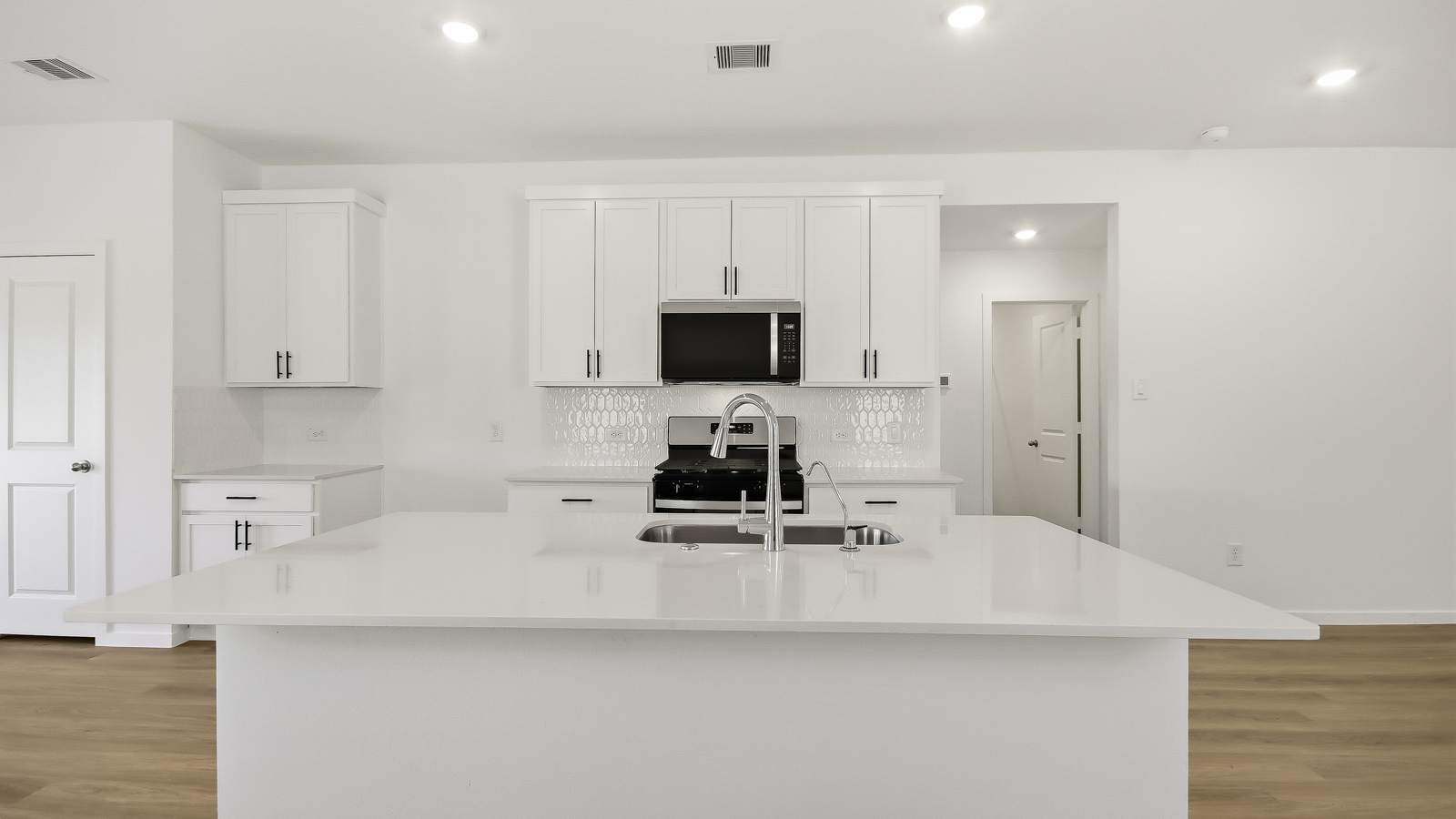 Kitchen with an island and vinyl floor