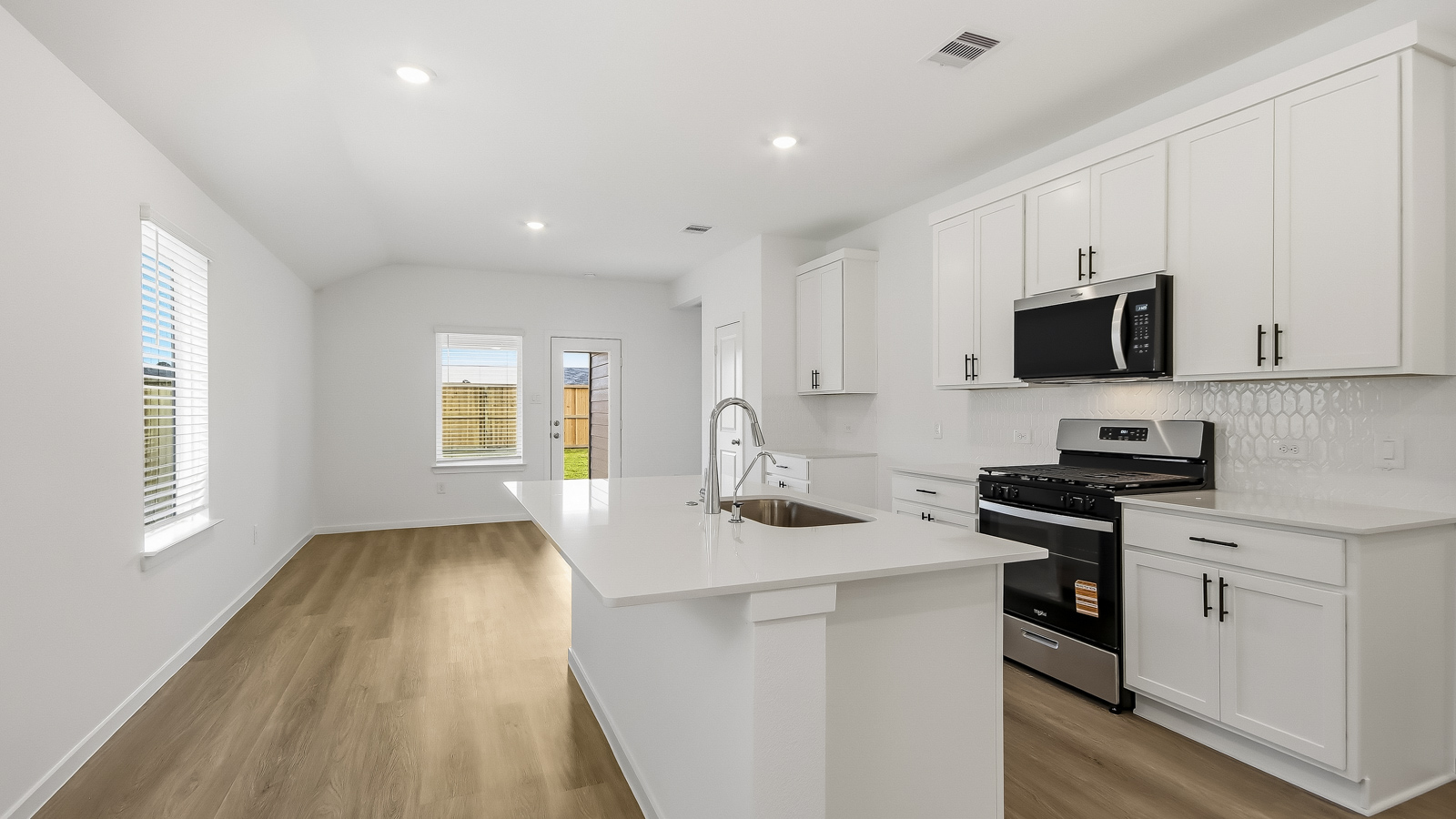 Kitchen with an island and vinyl floor