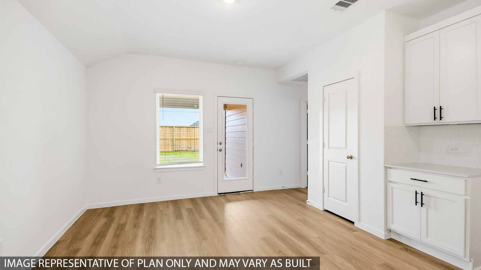Spacious living area with vinyl flooring