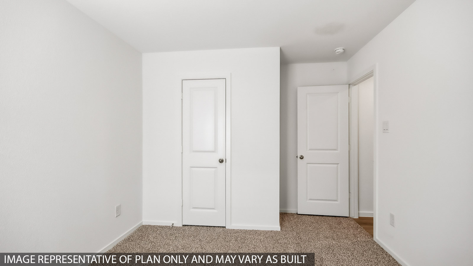 Secondary bedroom with carpet flooring
