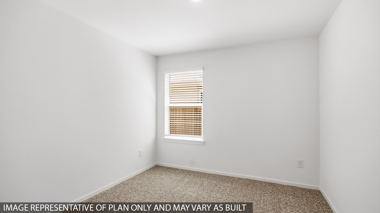 Secondary bedroom with carpet flooring