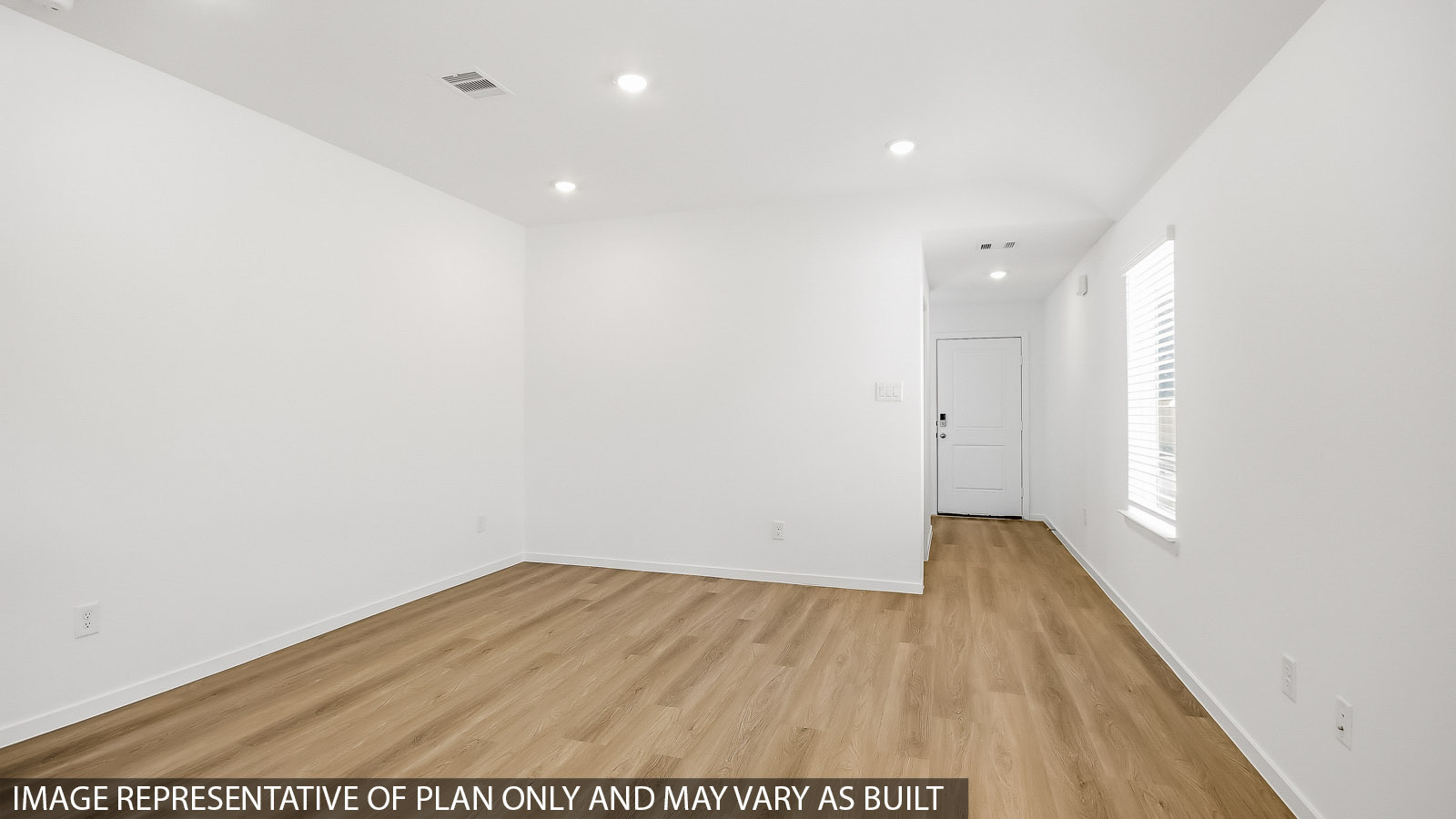 Spacious living area with vinyl flooring