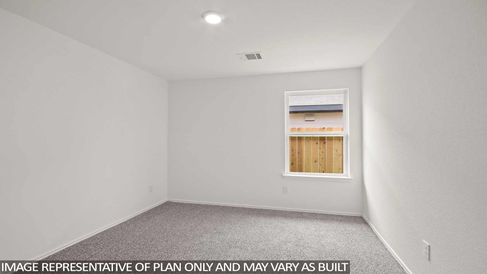 Secondary bedroom with carpet flooring