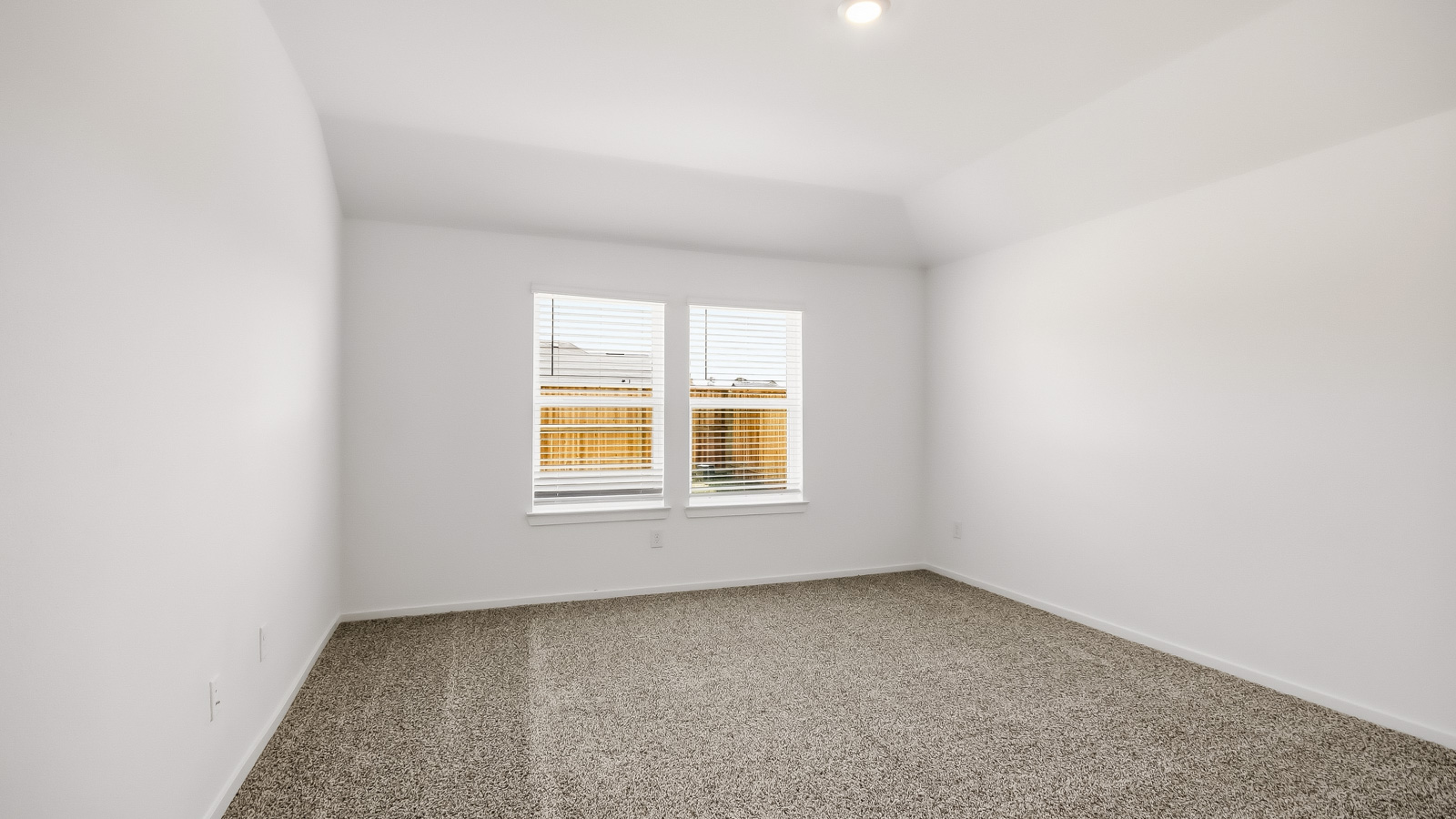 Primary bedroom with bright windows