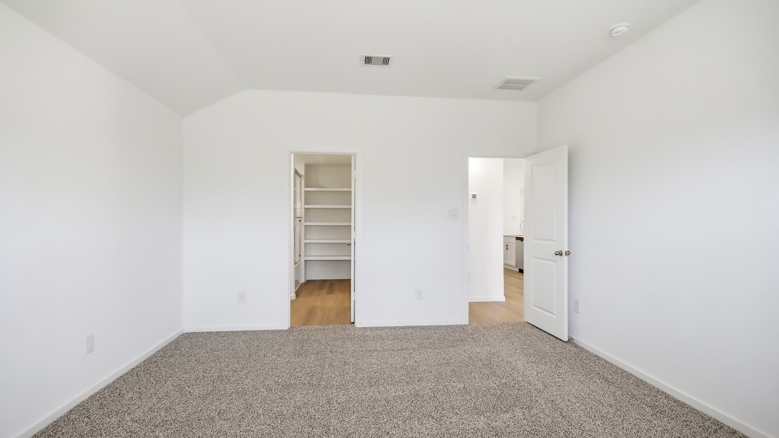 Primary bedroom with carpet flooring