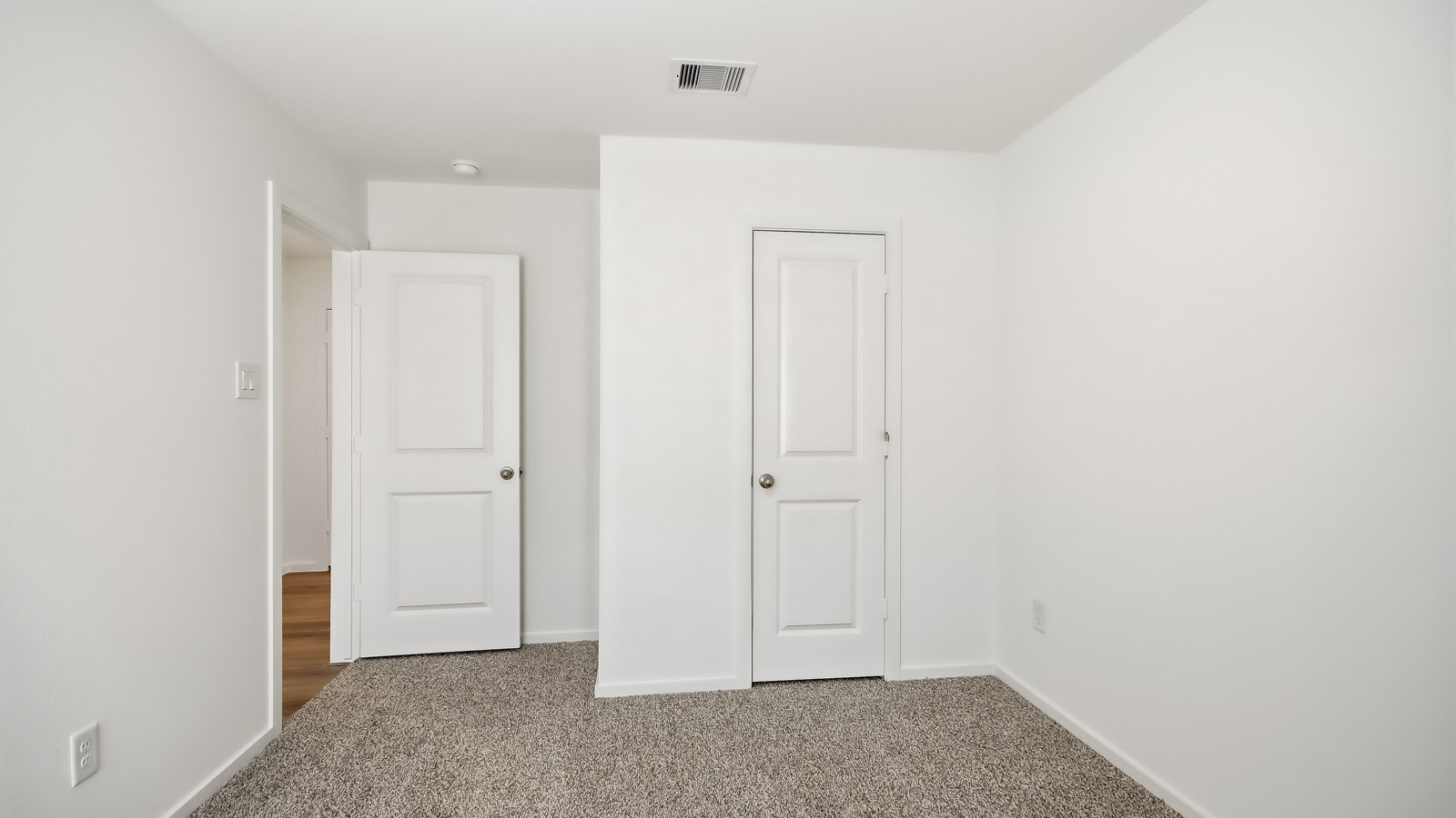 Secondary bedroom with carpet flooring