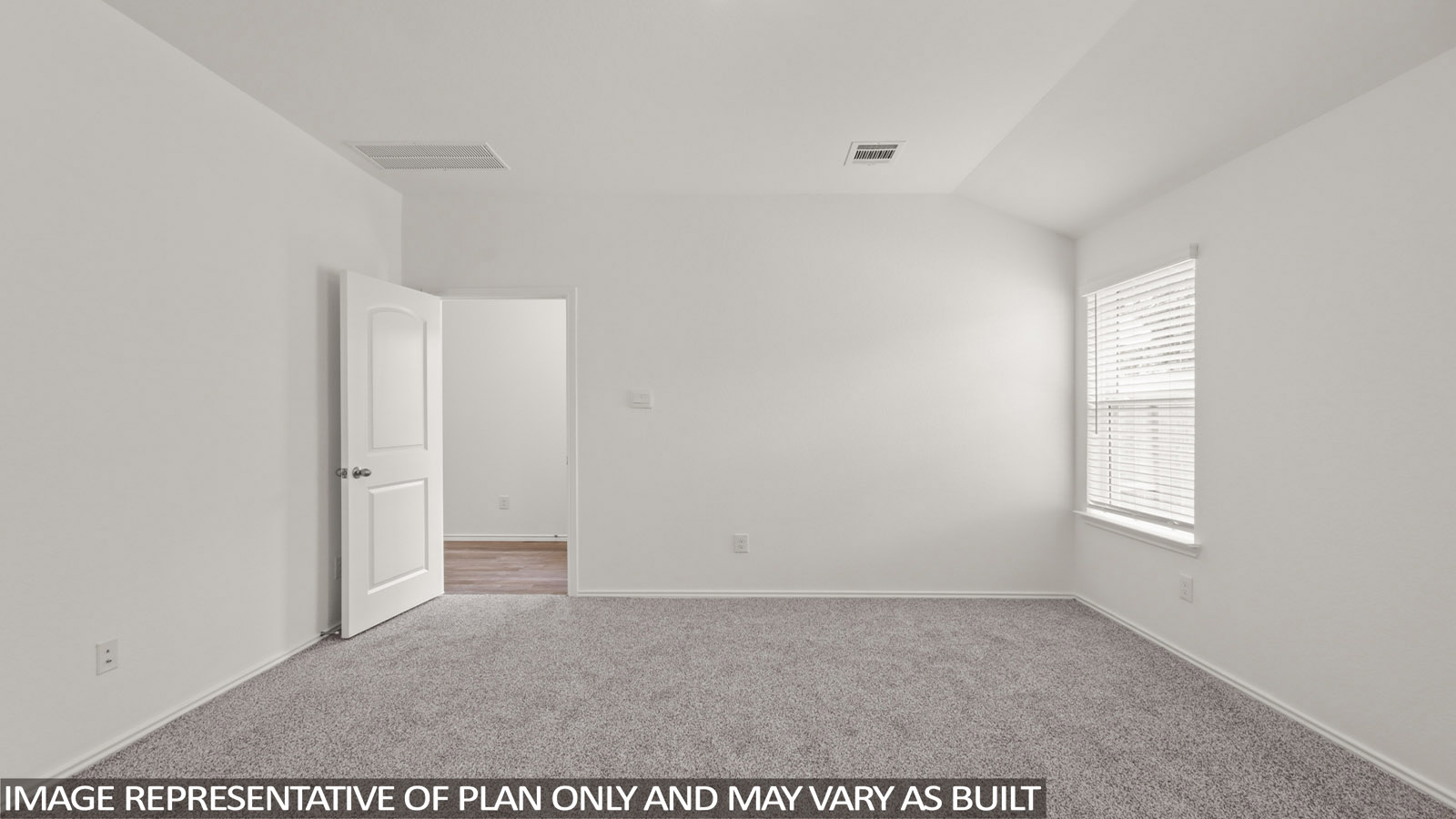 Primary bedroom with carpet flooring