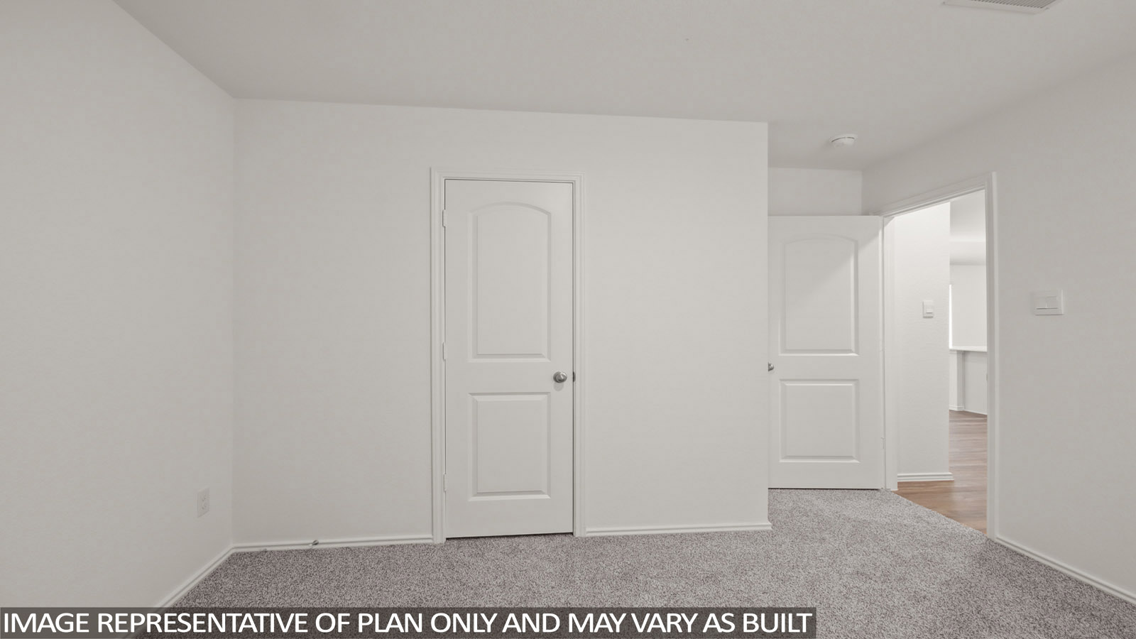 Secondary bedroom with carpet flooring