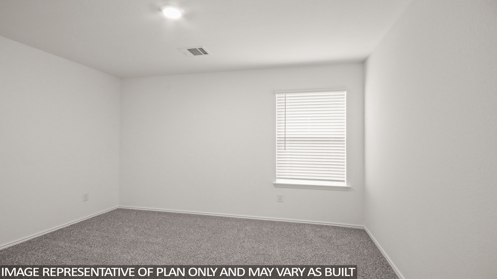 Secondary bedroom with carpet flooring