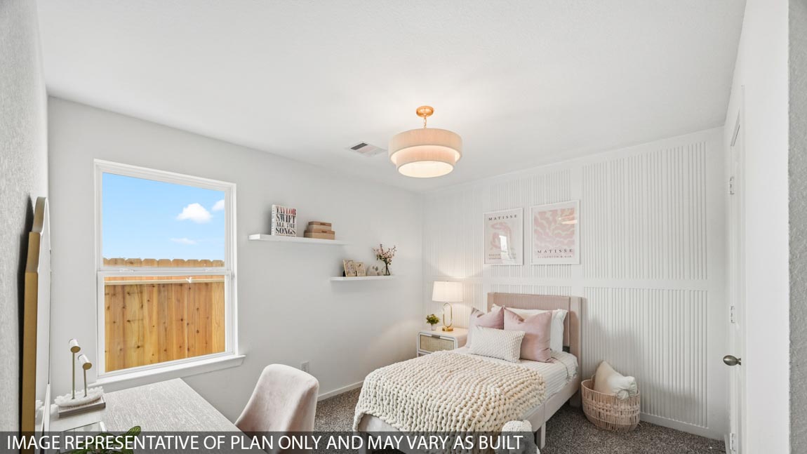 Secondary bedroom with carpet flooring