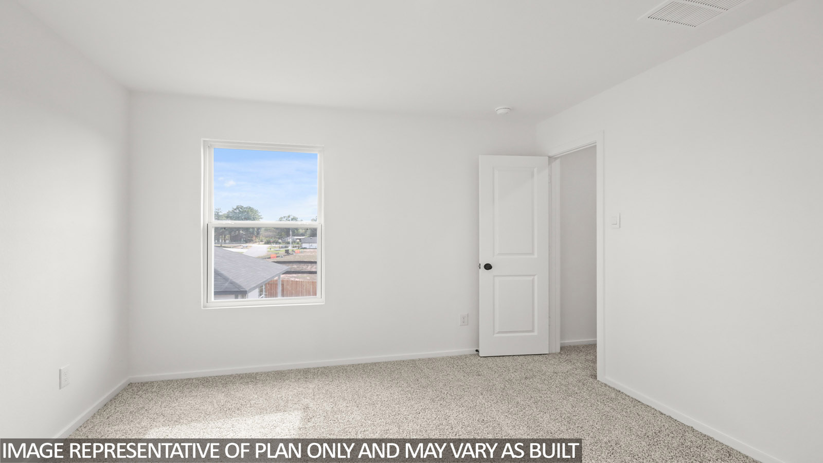 Secondary bedroom with carpet flooring