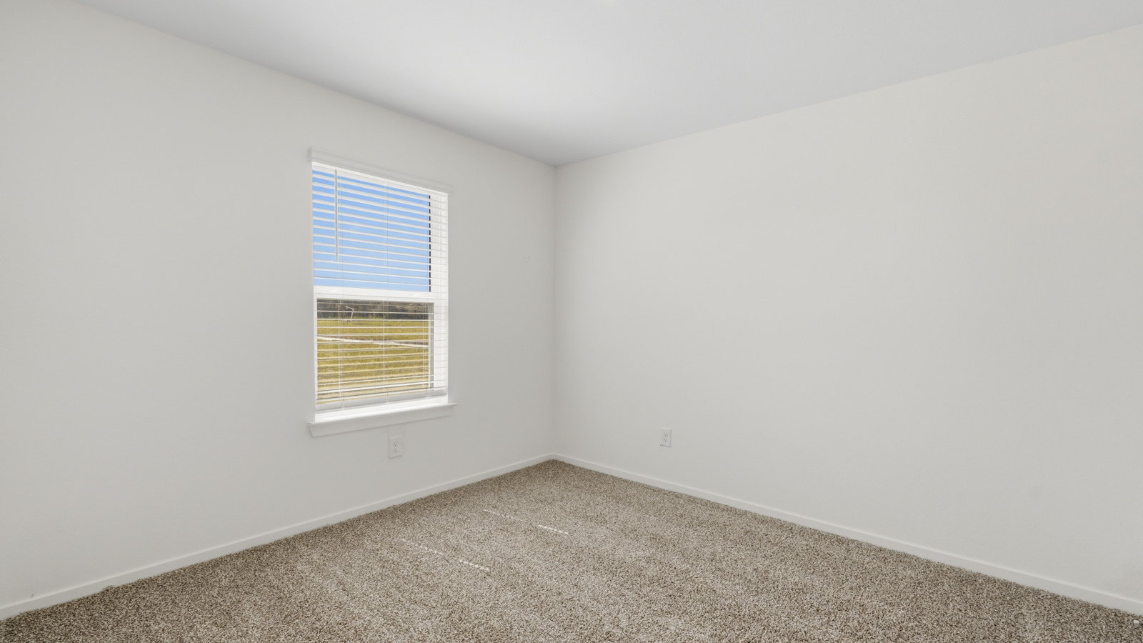 Secondary bedroom with carpet flooring