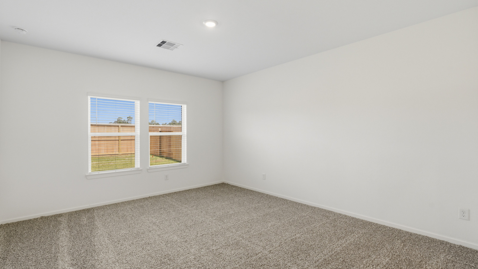 Primary bedroom with carpet flooring