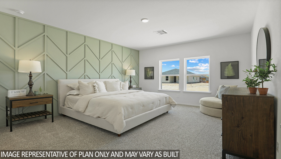 Primary bedroom with bright windows