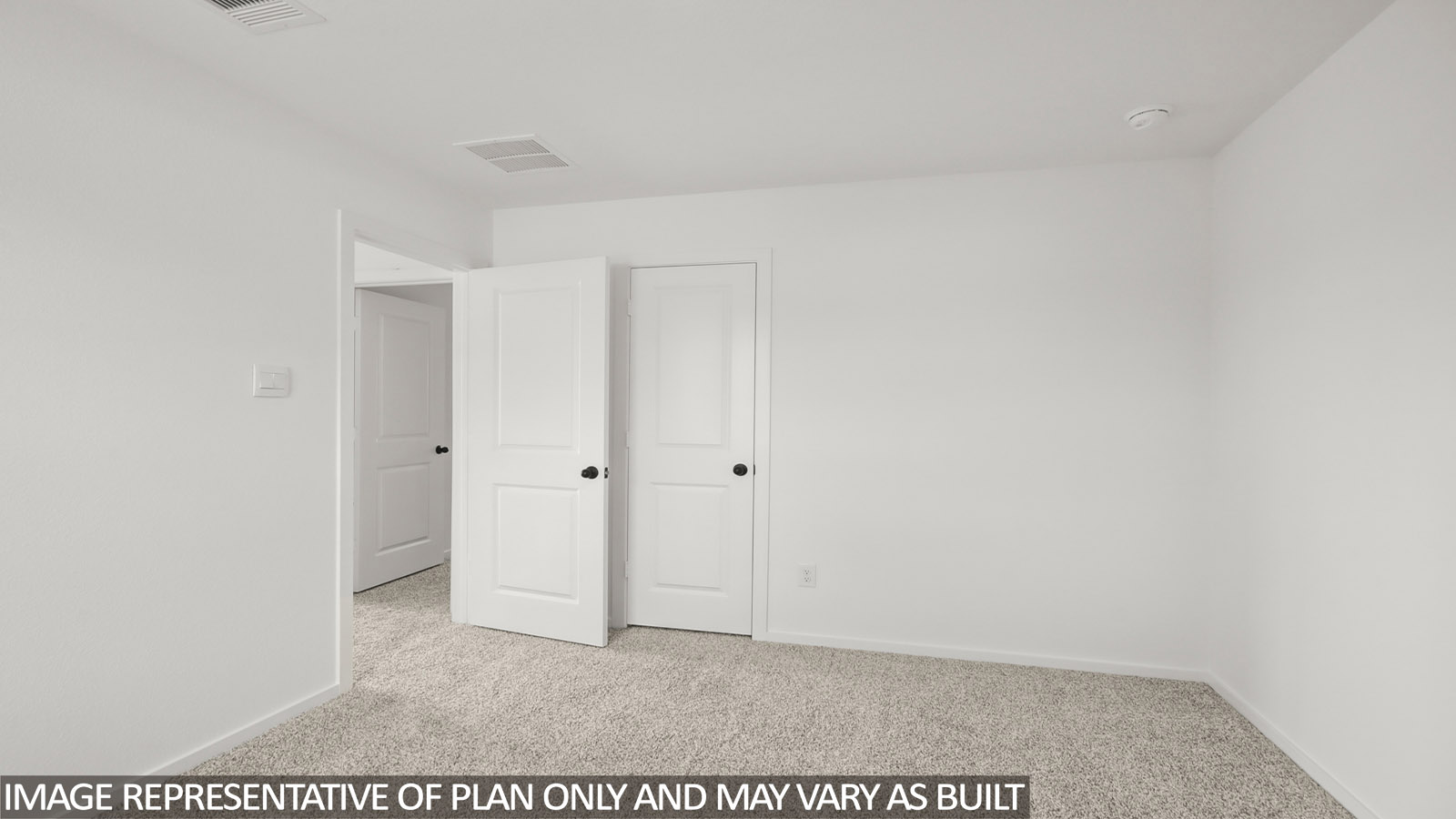 Secondary bedroom with carpet flooring