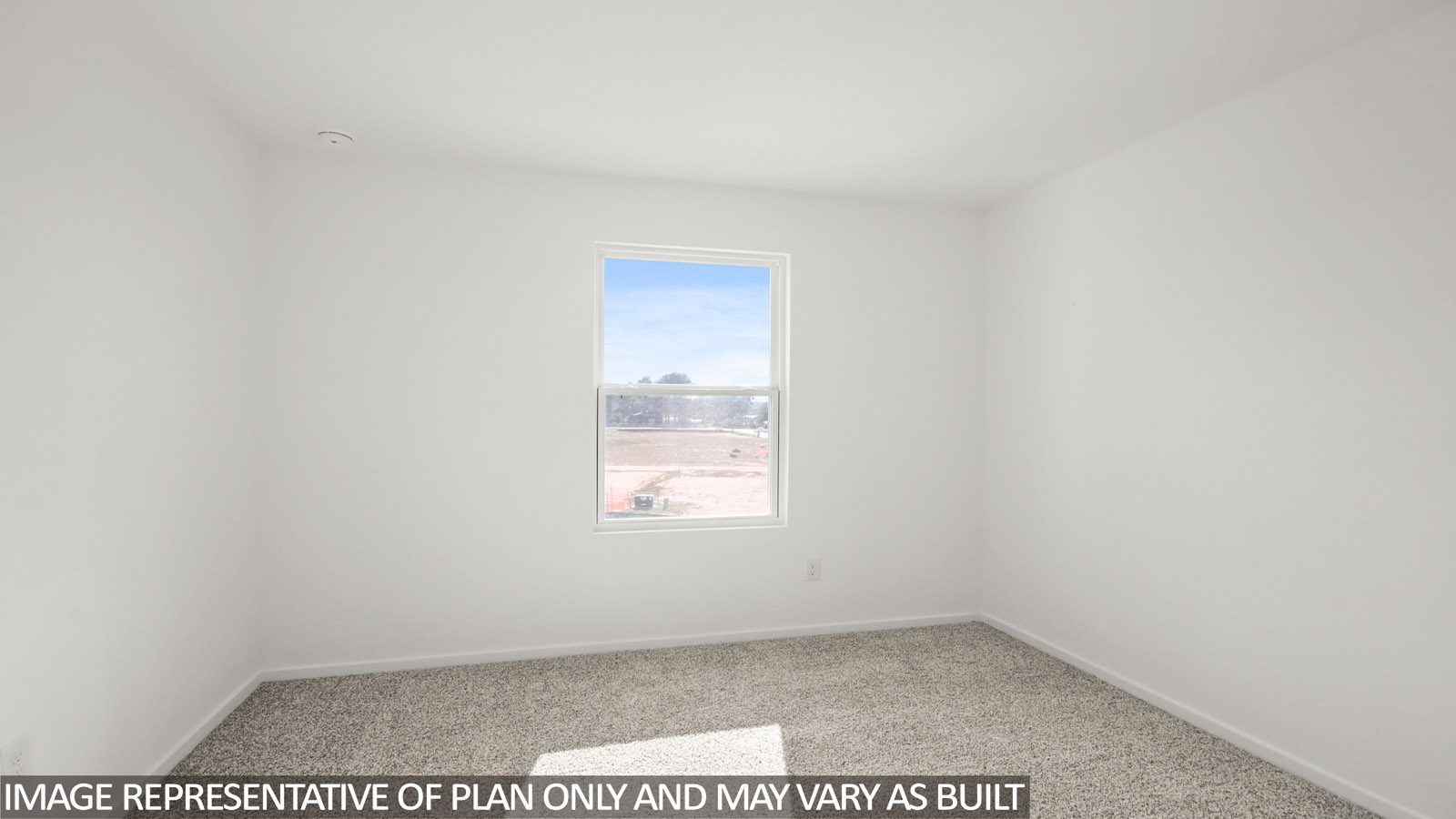 Secondary bedroom with carpet flooring