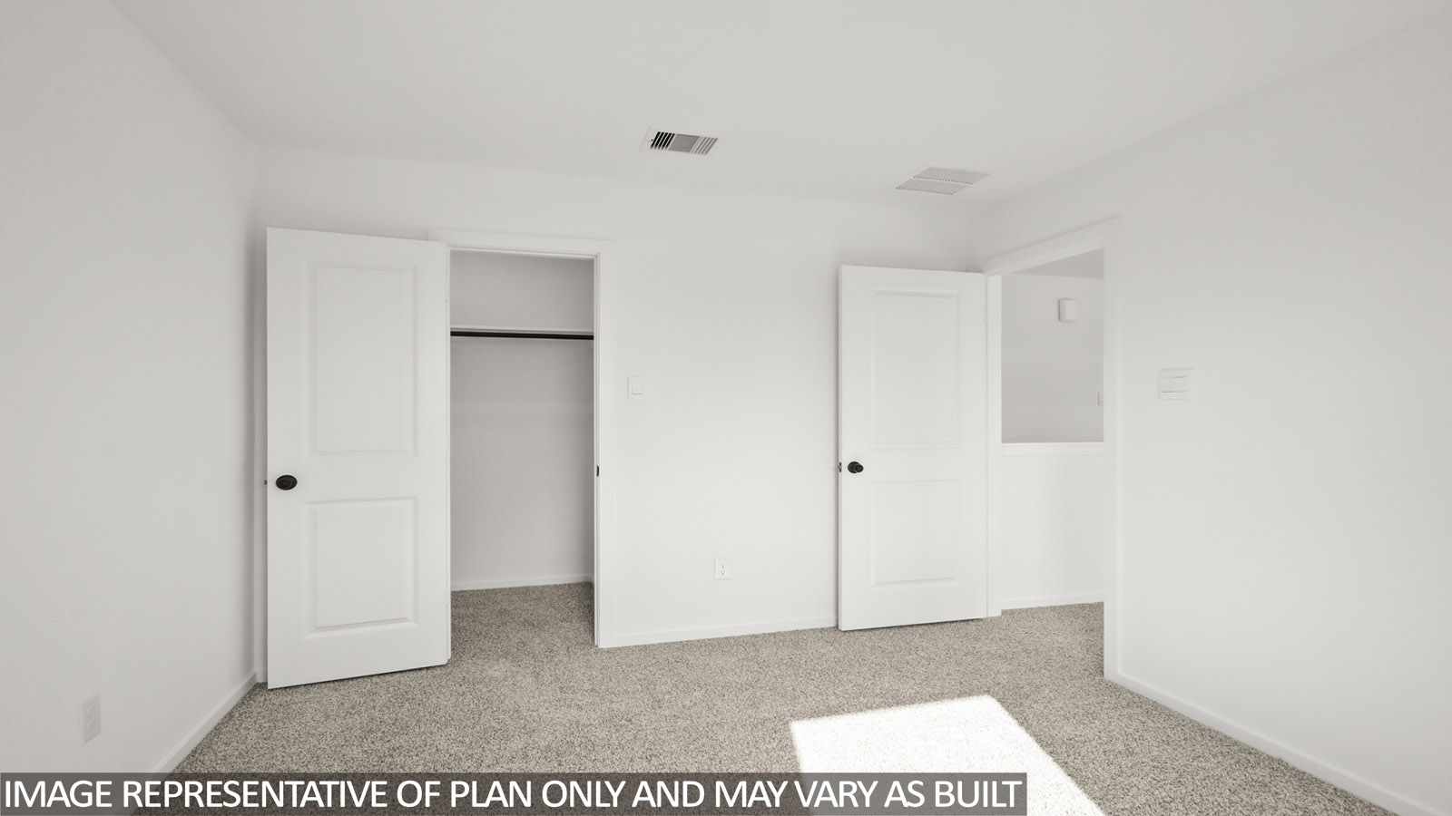 Secondary bedroom with carpet flooring