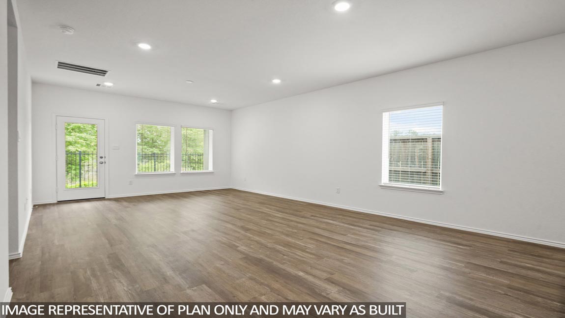 Spacious living area with vinyl flooring