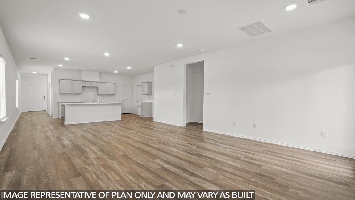 Spacious living area with vinyl flooring
